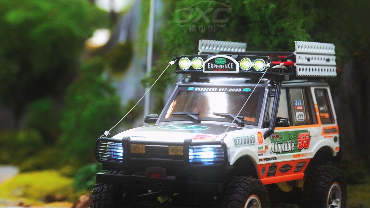1/12 scale RC off-road crawler with detailed body design and LED lighting system.