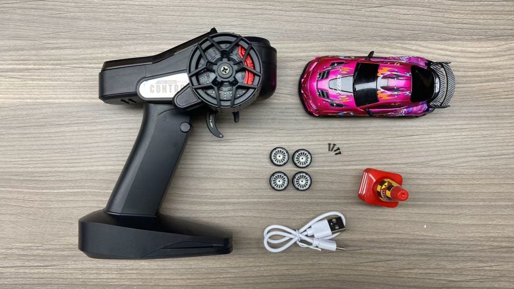 JXC RC toy spare parts kit with screws USB cable and replacement tires.