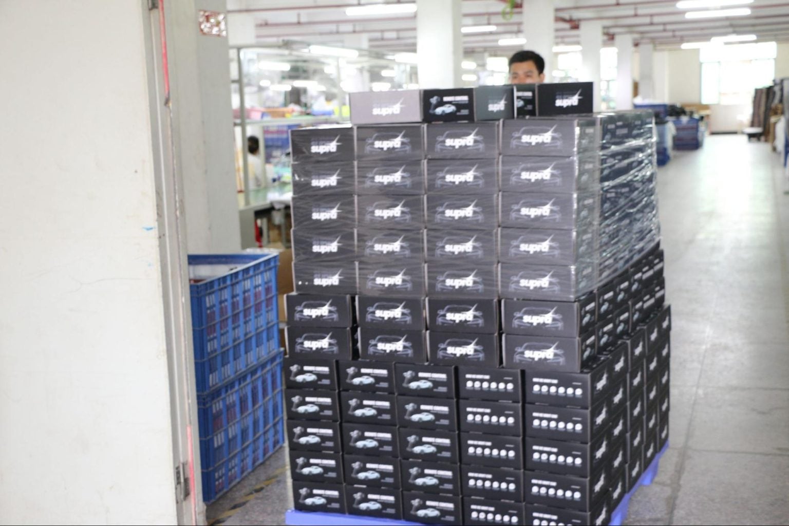 Stacks of JXC Model Supra RC car boxes prepared for packaging and shipment inside the RC car manufacturing factory