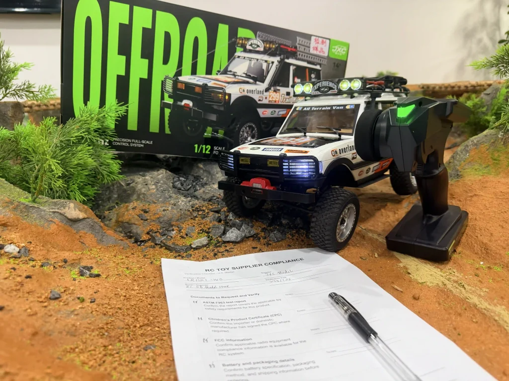RC toy supplier compliance checklist placed in front of JXC LC80 1/12 RC crawler and box.