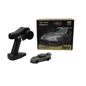 1:43 Toyota Supra RC drift car, box, remote, four spare tires, USB cable, and cones.