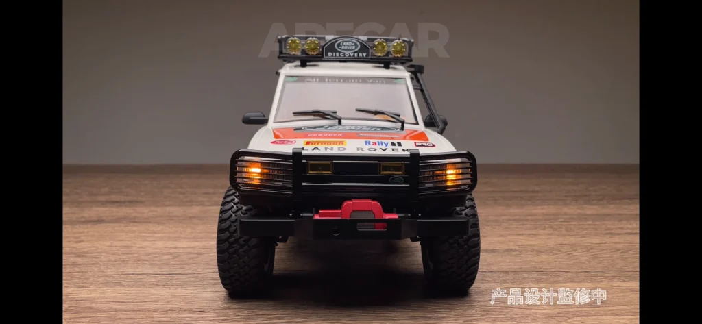 White LR1201 1:12 Land Rover Discovery RC crawler, front view with roof light bar and bull bar
