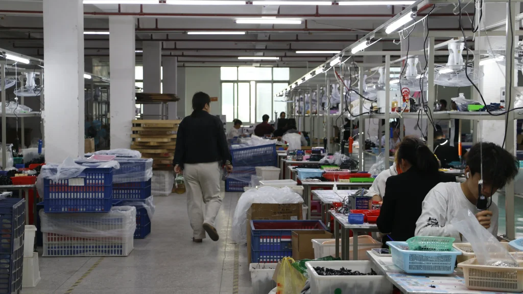 Workers assembling RC toys on factory production line