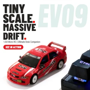JXC EVO6409 red DriftMAXX RC drift car parked on a desk beside keyboard keycaps