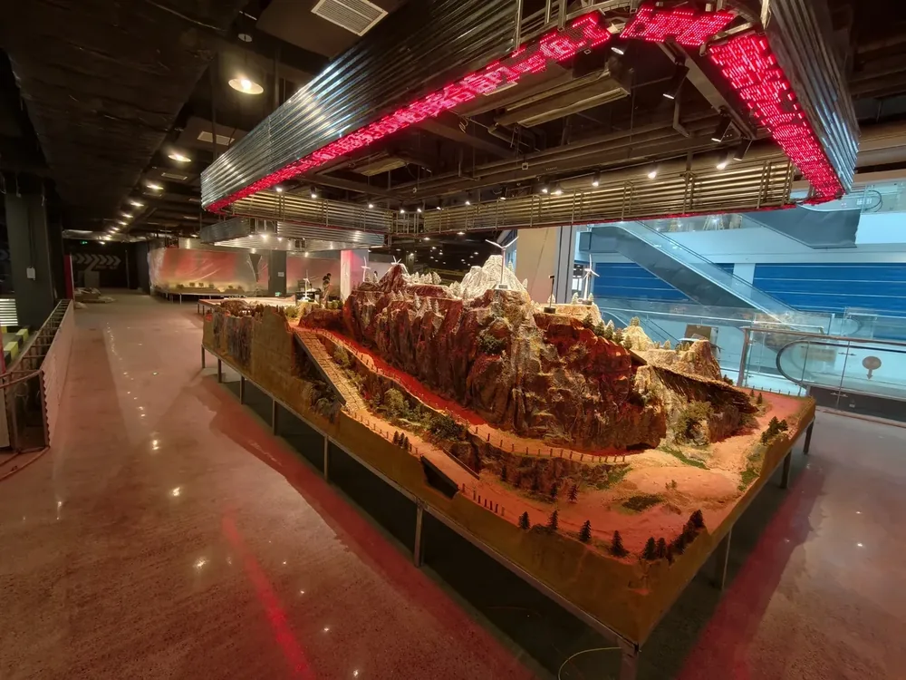 Large indoor RC diorama track installed in a shopping mall as an anchor attraction