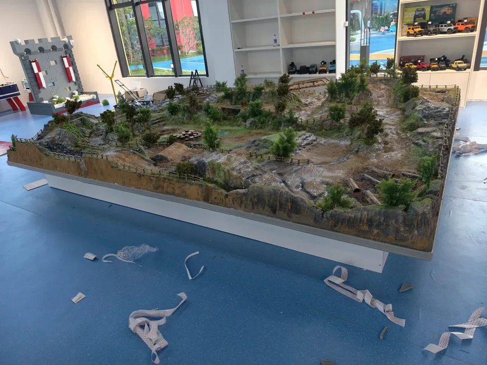 Full-size indoor RC diorama track assembled end to end on the factory floor at JXC Model